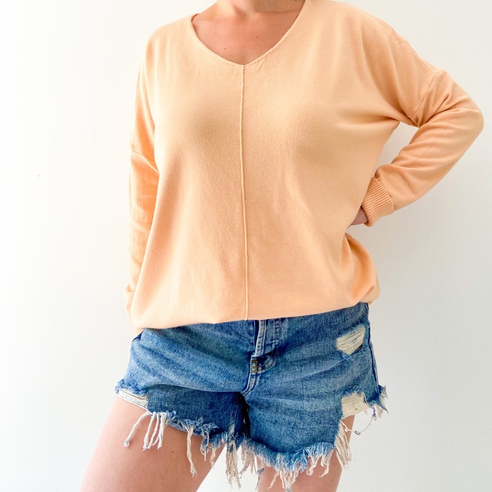 Creamsicle colored v-neck sweater